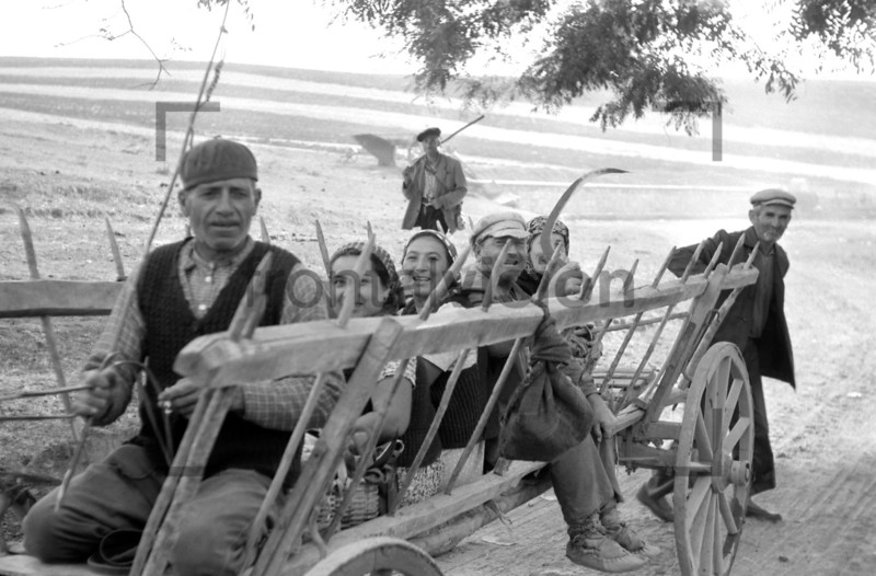 Rural people sitting on a carriage Historic image from 1965 