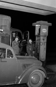 Car and lorry at a filling station: Historical image