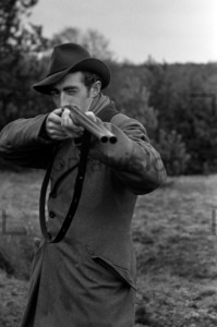 Young hunter holds a rifle: Historical image