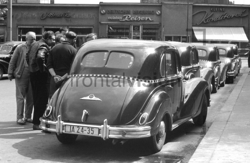 Taxi driver and taxicab at S-Bahnhof Friedrichstraße East Berlin 1962 
